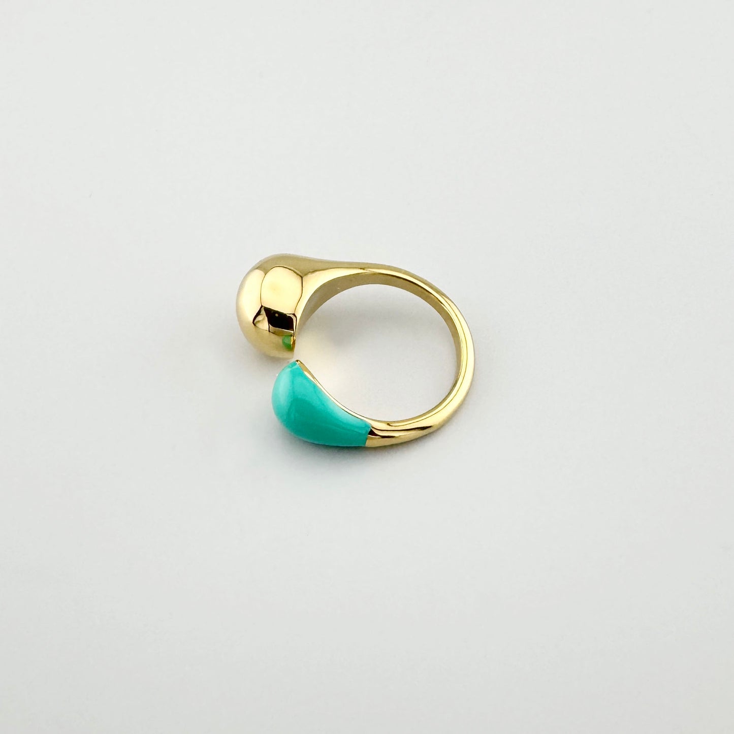 Asymmetrical ring with turquoise enamel and gold drop, French brand Ikita.