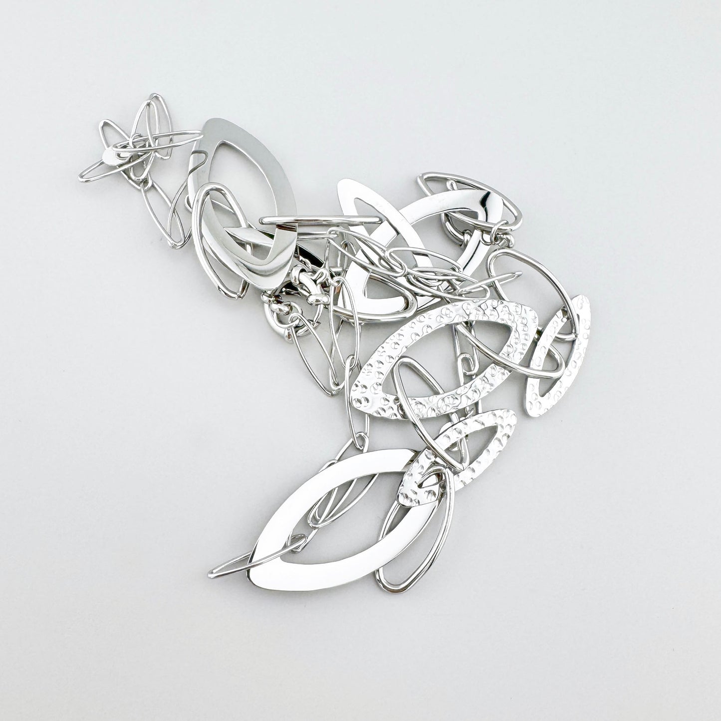Stainless steel necklace with hammered and smooth elliptical links, French brand Ikita.