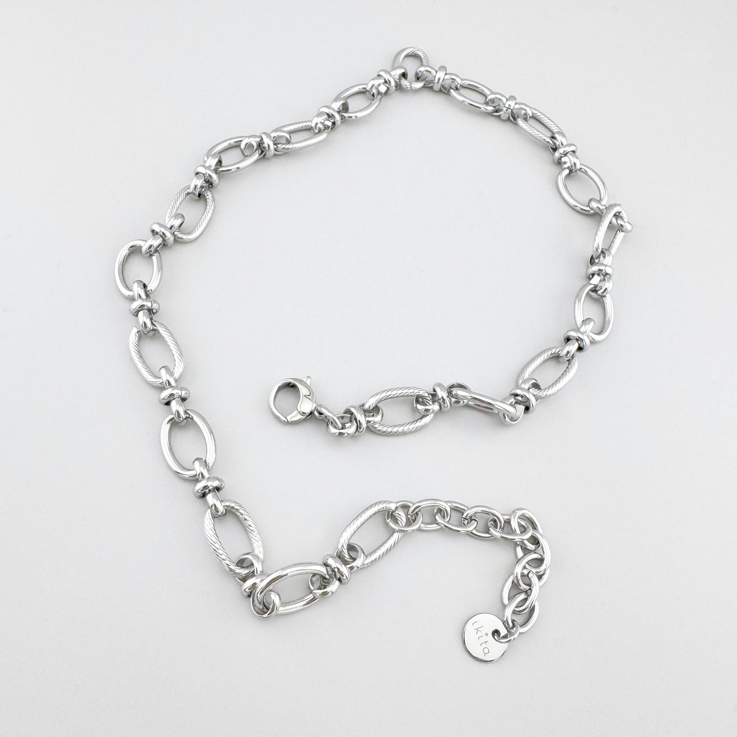 Stainless steel necklace with smooth and textured oval links, French brand Ikita.