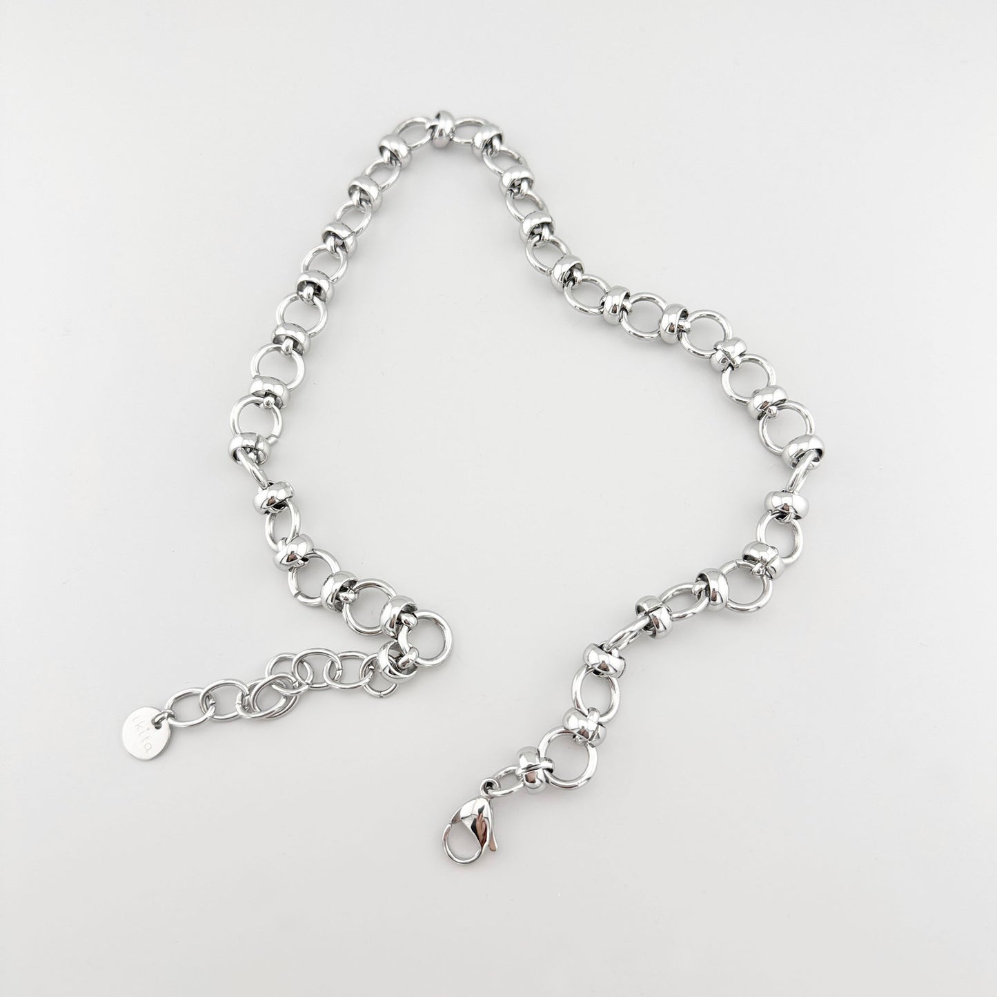 Stainless steel necklace with polished round links, French brand Ikita.