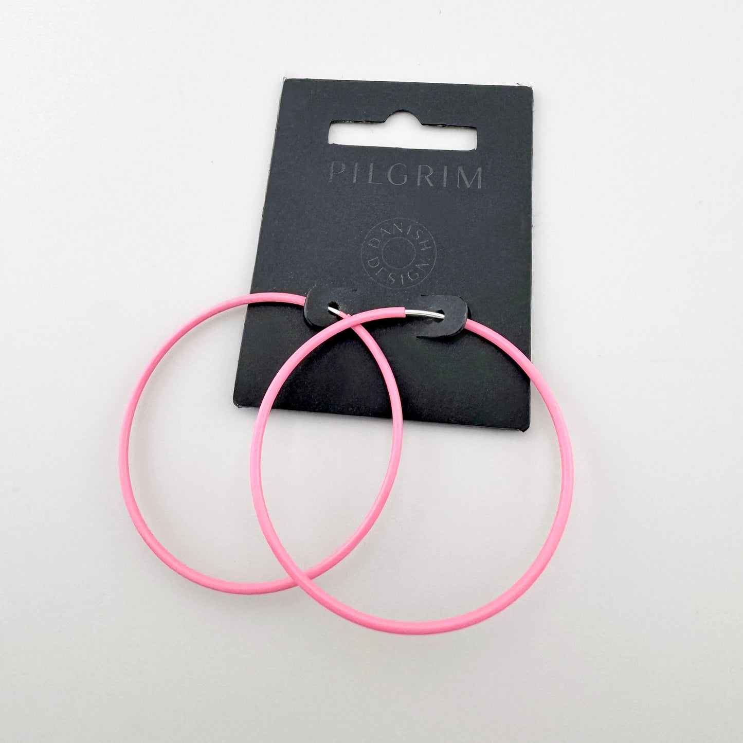 Pendientes circulares en color rosa intenso con acabado mate, marca danesa Pilgrim.
