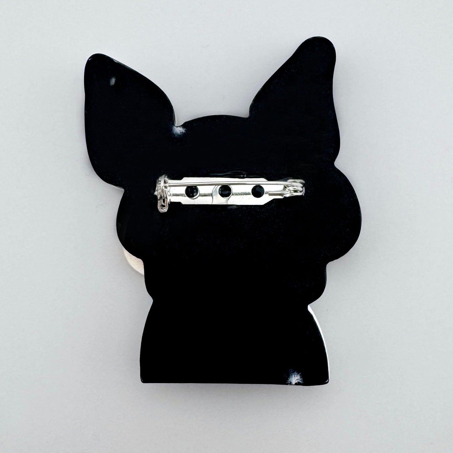 Bulldog-shaped brooch with glasses, designed in a pop-art style.