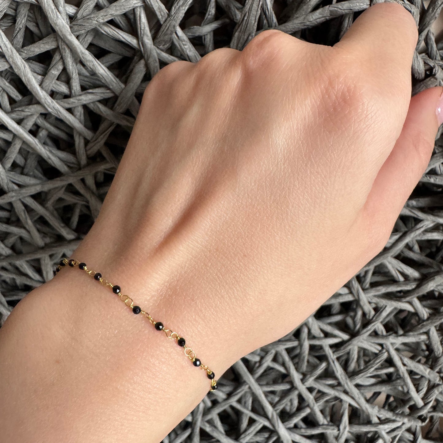 Gold-tone bracelet with faceted black crystals, French brand IRL.