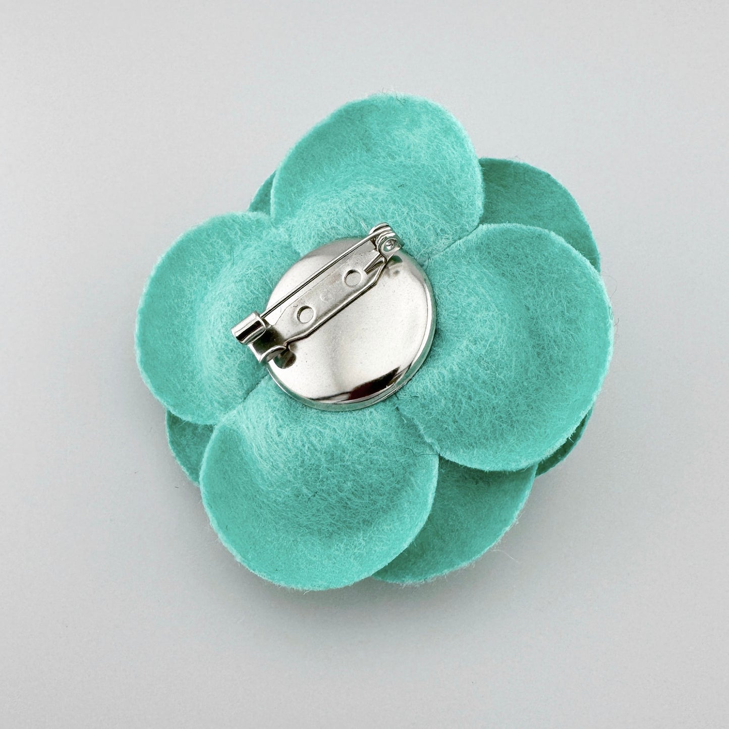 Handmade turquoise felt flower-shaped brooch, Spanish brand Sonata.