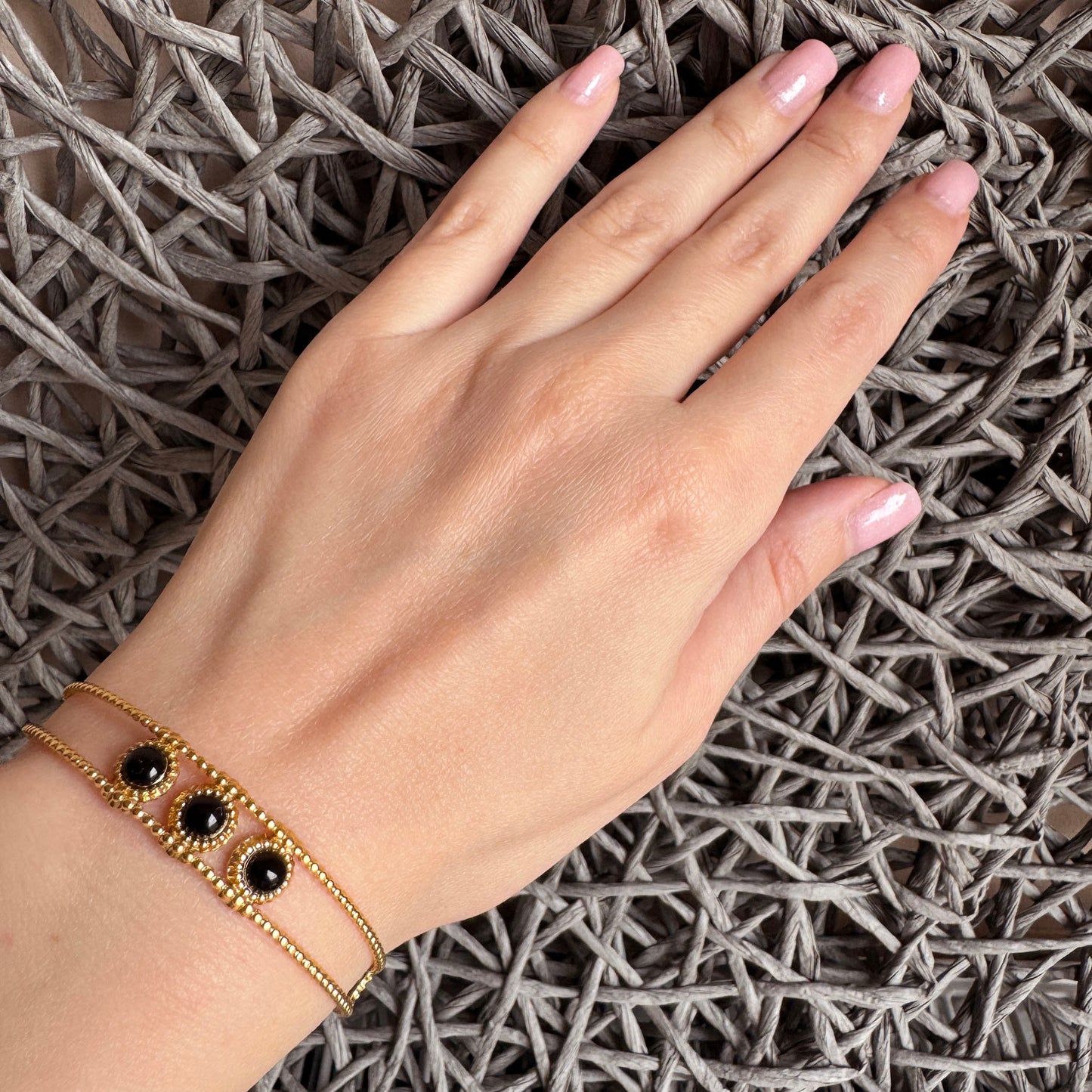 Gold-tone bracelet with three black agate stones, French brand IRL.
