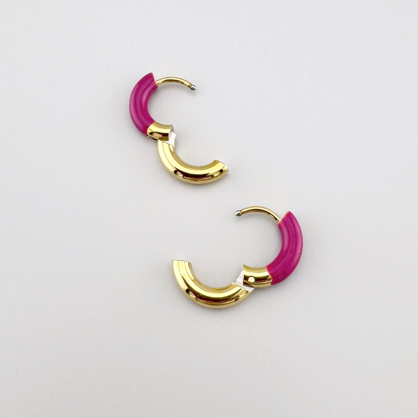 Gold hoop earrings with pink enamel, French brand Ikita.