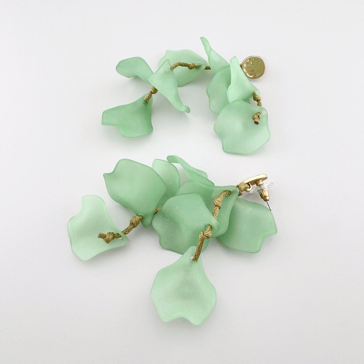Dangling earrings with green matte petals and gold accents, Spanish brand Sonata.