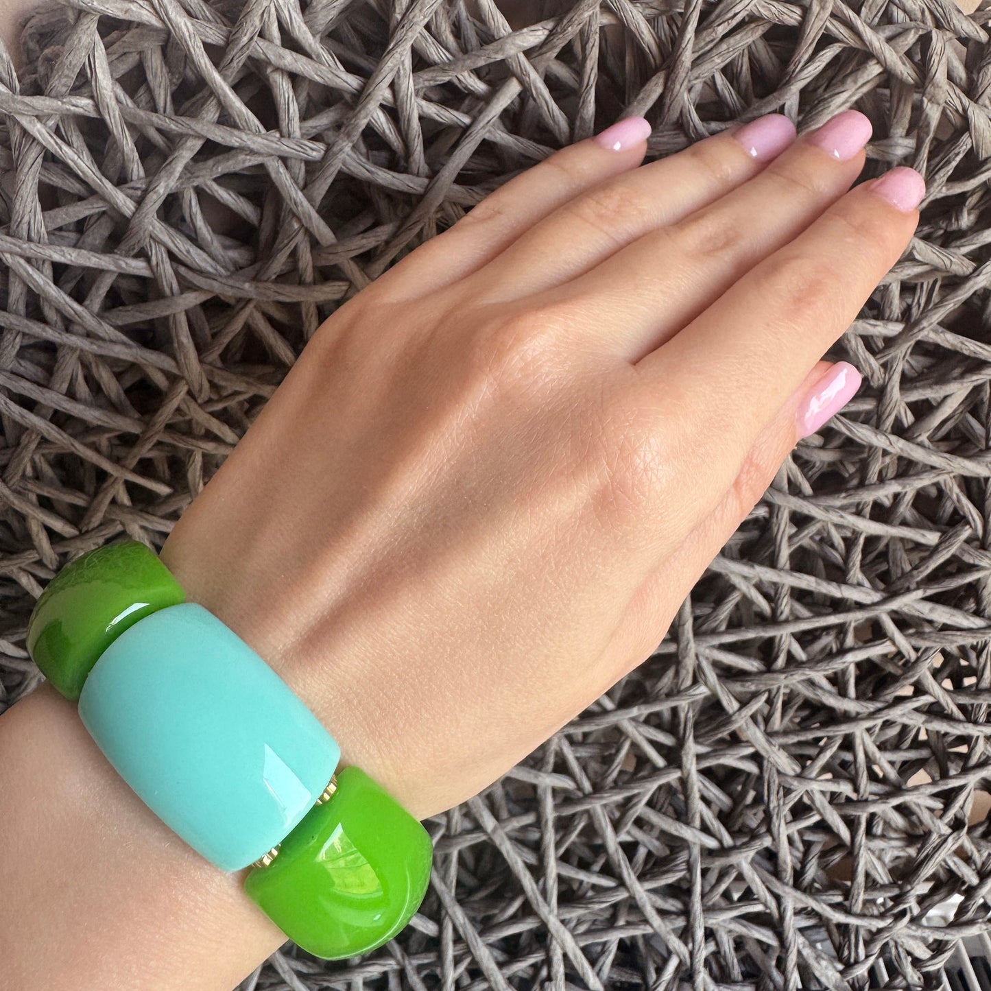 Plastic bracelet in green and blue tones with geometric segments, French brand Ikita.