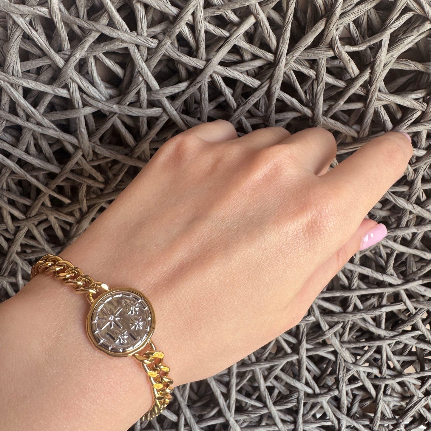Gold-plated stainless steel bracelet with a two-tone star motif medallion, French brand Ikita.