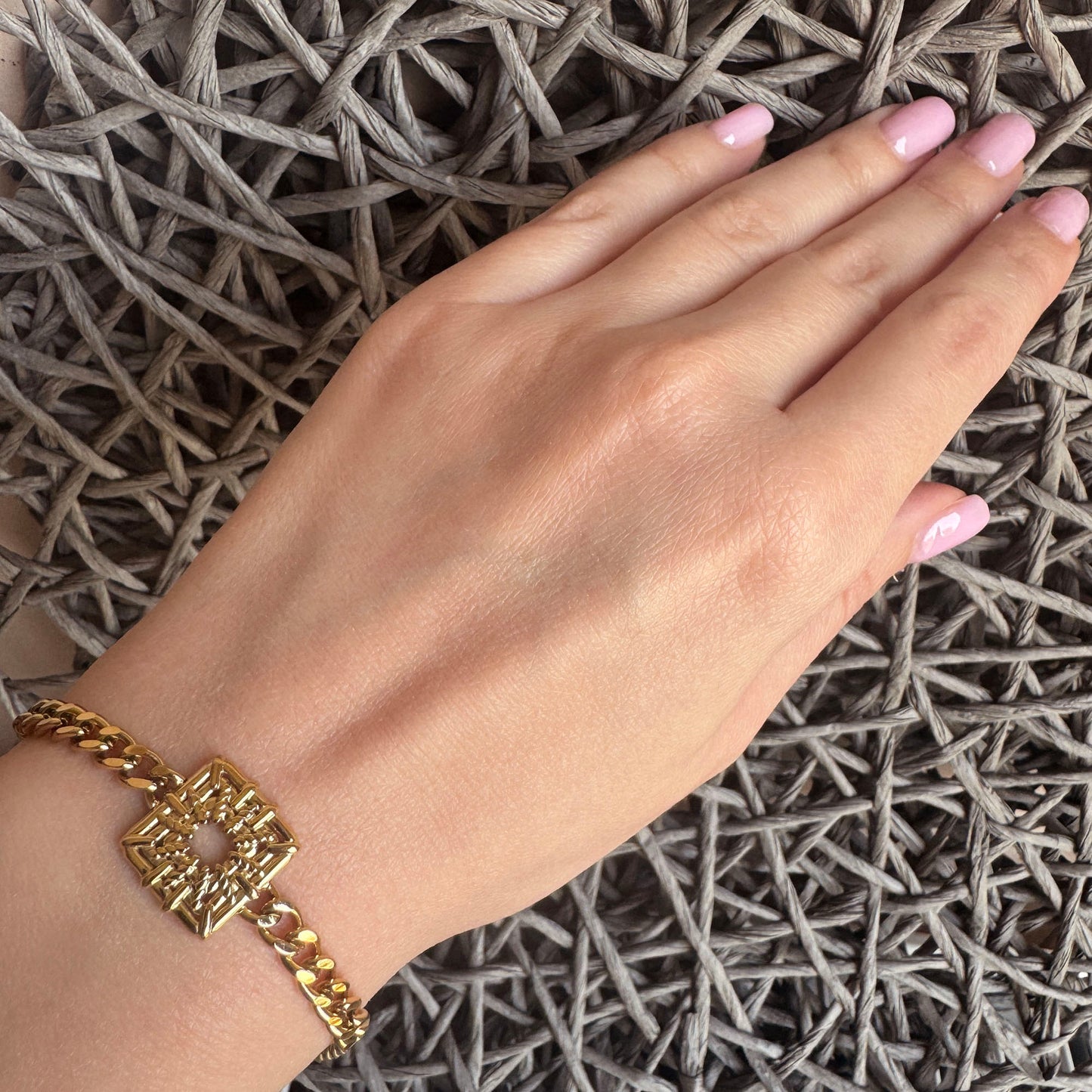 Gold-plated stainless steel bracelet with a geometric openwork square element, French brand Ikita.