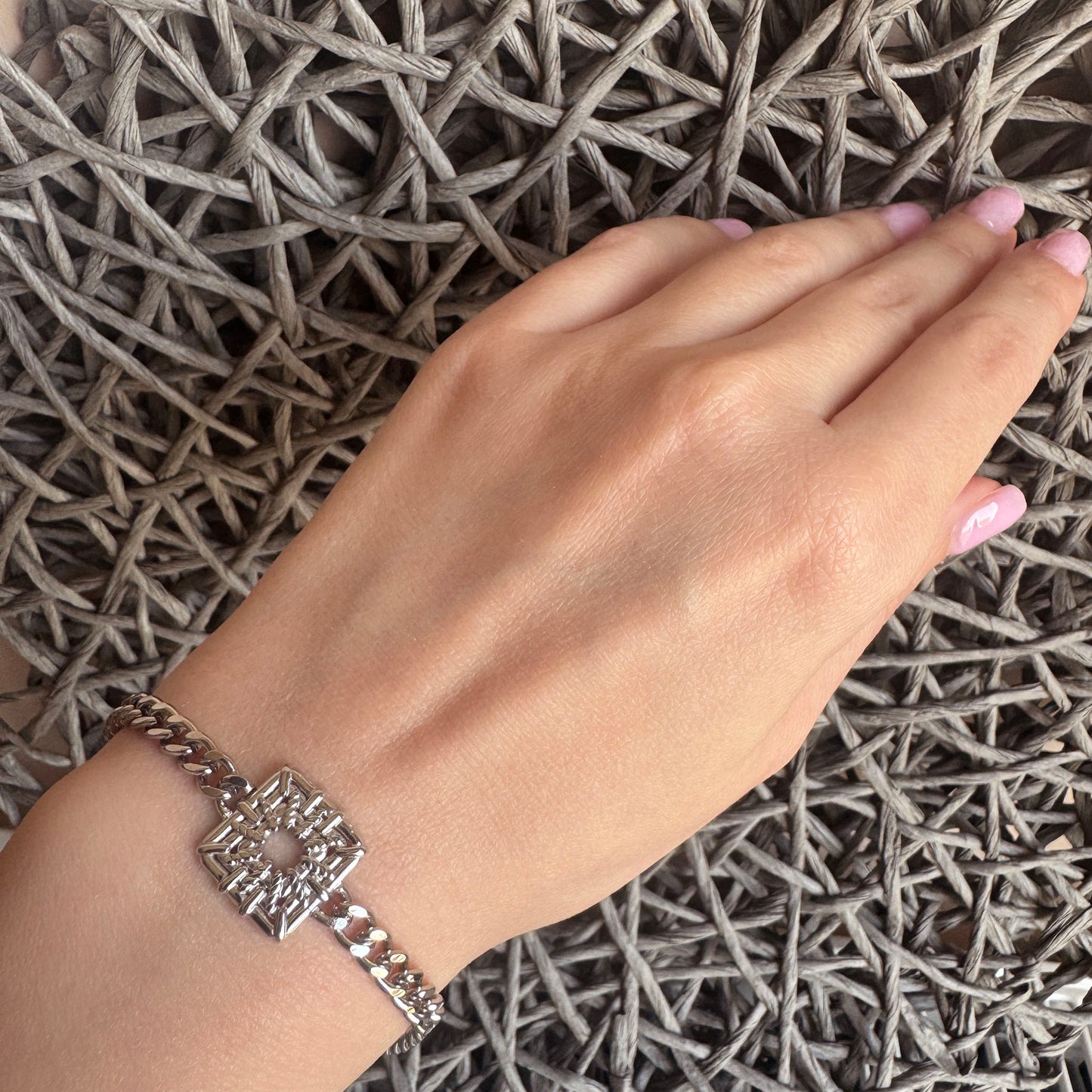 Stainless steel chain bracelet with openwork square centerpiece, French brand Ikita.