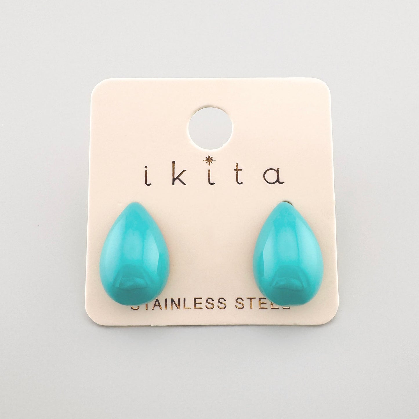 Drop-shaped earrings in a vibrant turquoise color, by French brand Ikita.