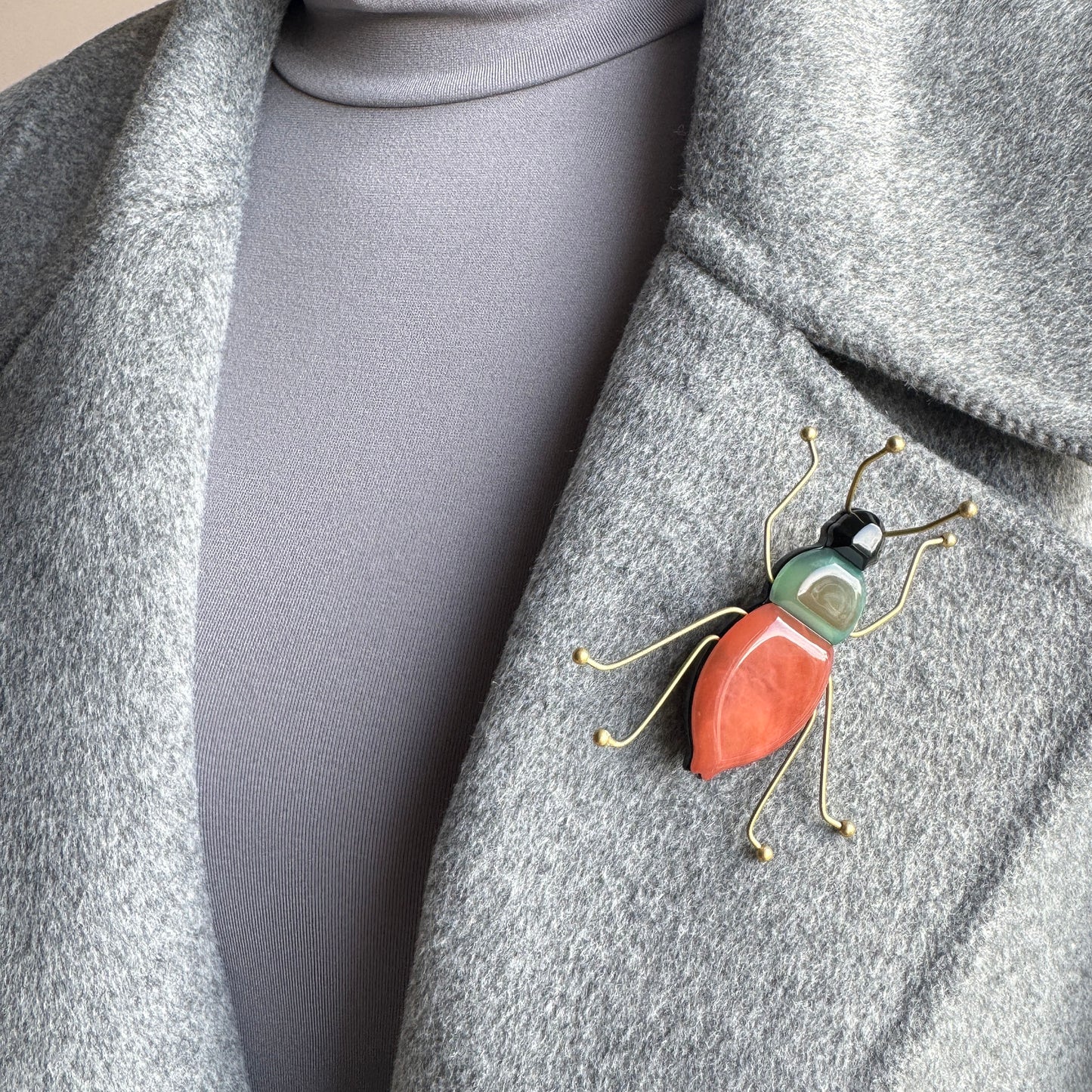 Brooch shaped like a stylized insect made of colored acrylic and gold-toned metal, Spanish brand Sonata.
