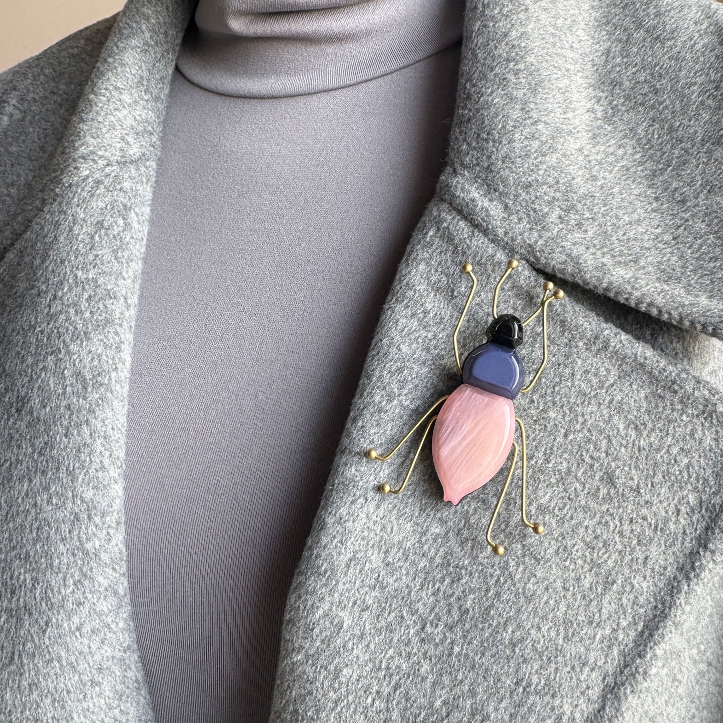 Brooch in the shape of a stylized beetle with a pink and navy acrylic body, Spanish brand Sonata.