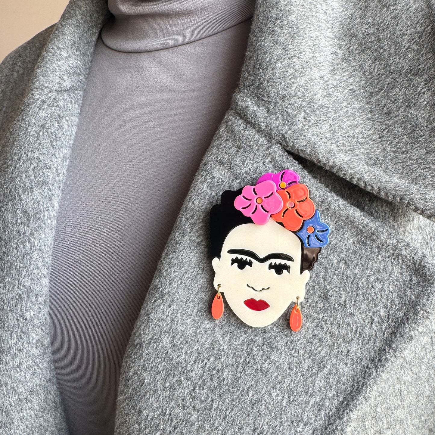 Brooch featuring Frida Kahlo with colorful flowers and red lips, Spanish brand Sonata.