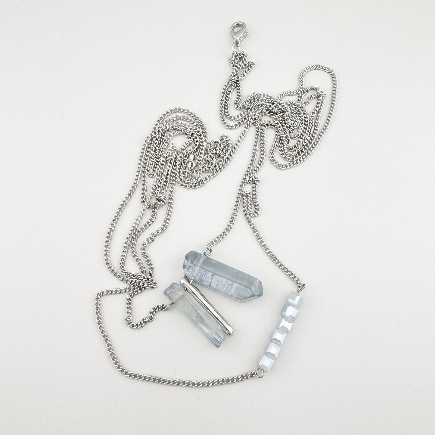 Boho-style silver necklace with natural stones and ice-blue crystals, Spanish brand Maravillas.
