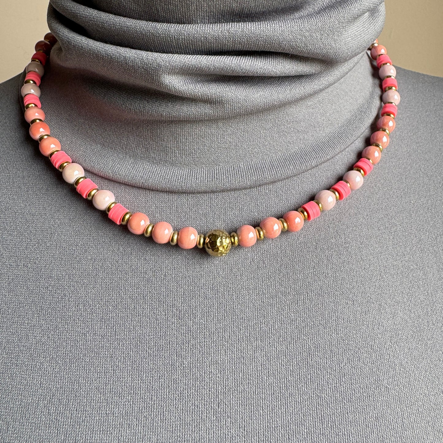 Necklace with pink pearl-like ceramic beads and a central gold accent, French brand Ikita.
