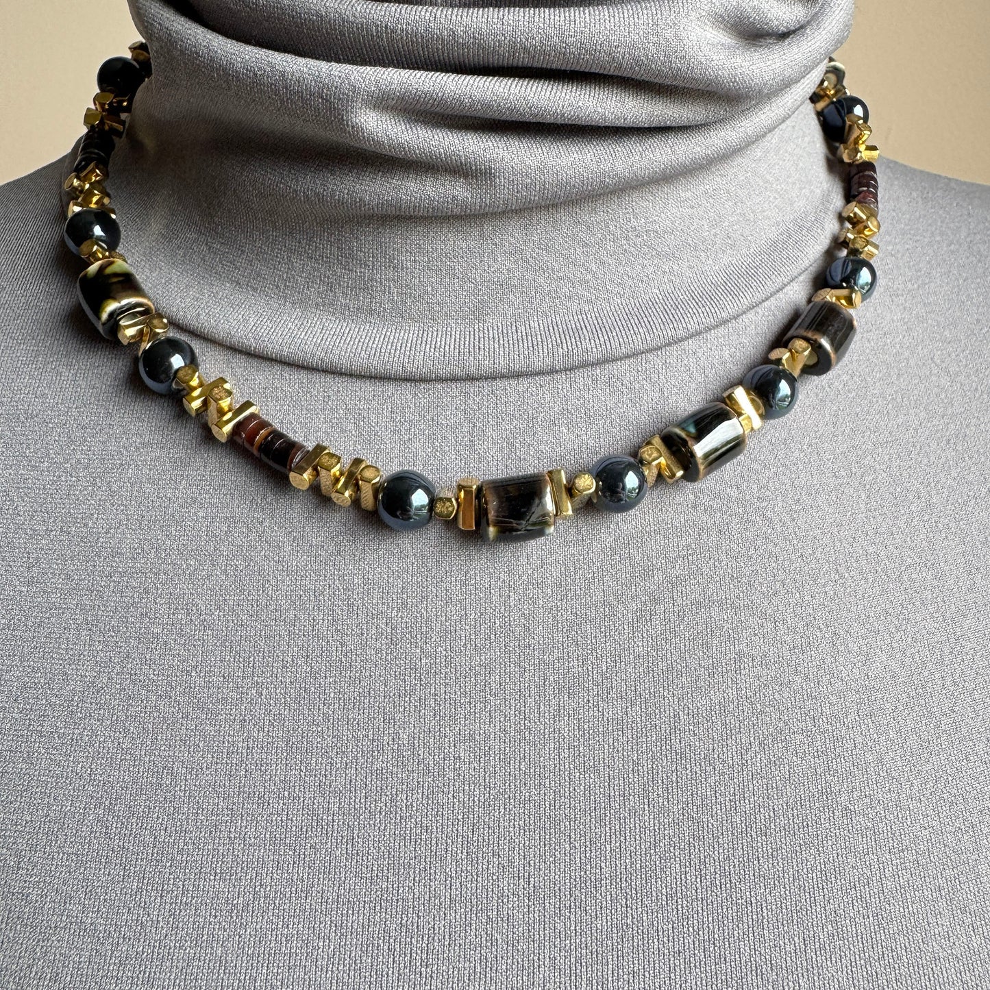 Necklace with graphite ceramic beads and gold-tone metallic accents, French brand Ikita.