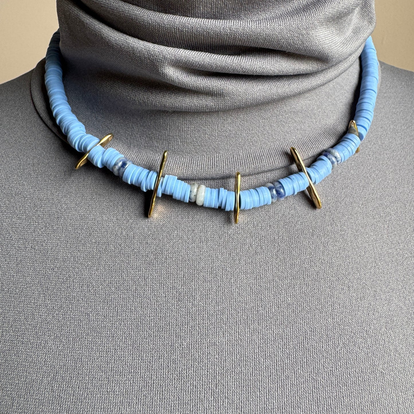 Choker necklace with blue polymer discs and sodalite stones, accented with gold details, French brand Ikita.