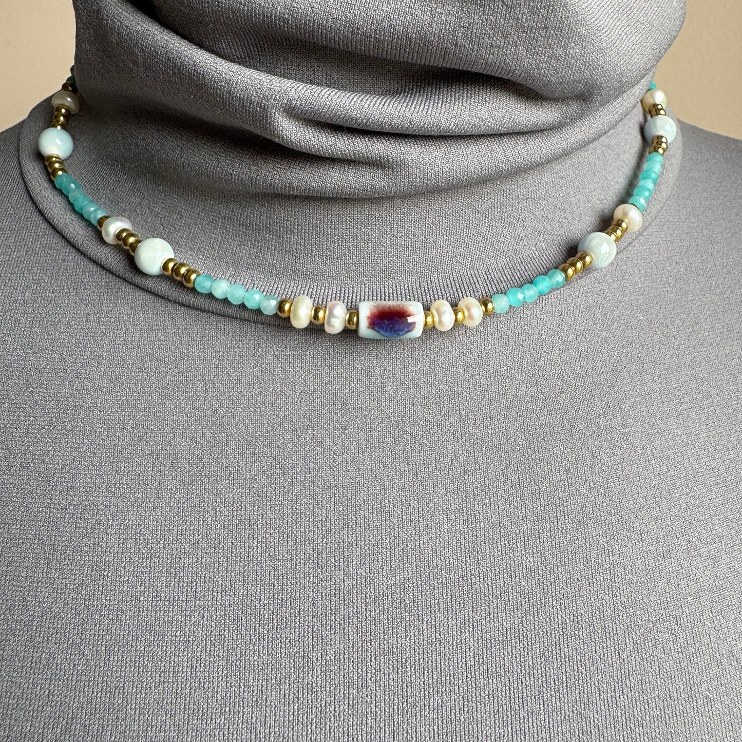 Necklace with turquoise beads, pearls and a ceramic pendant, French brand Ikita.