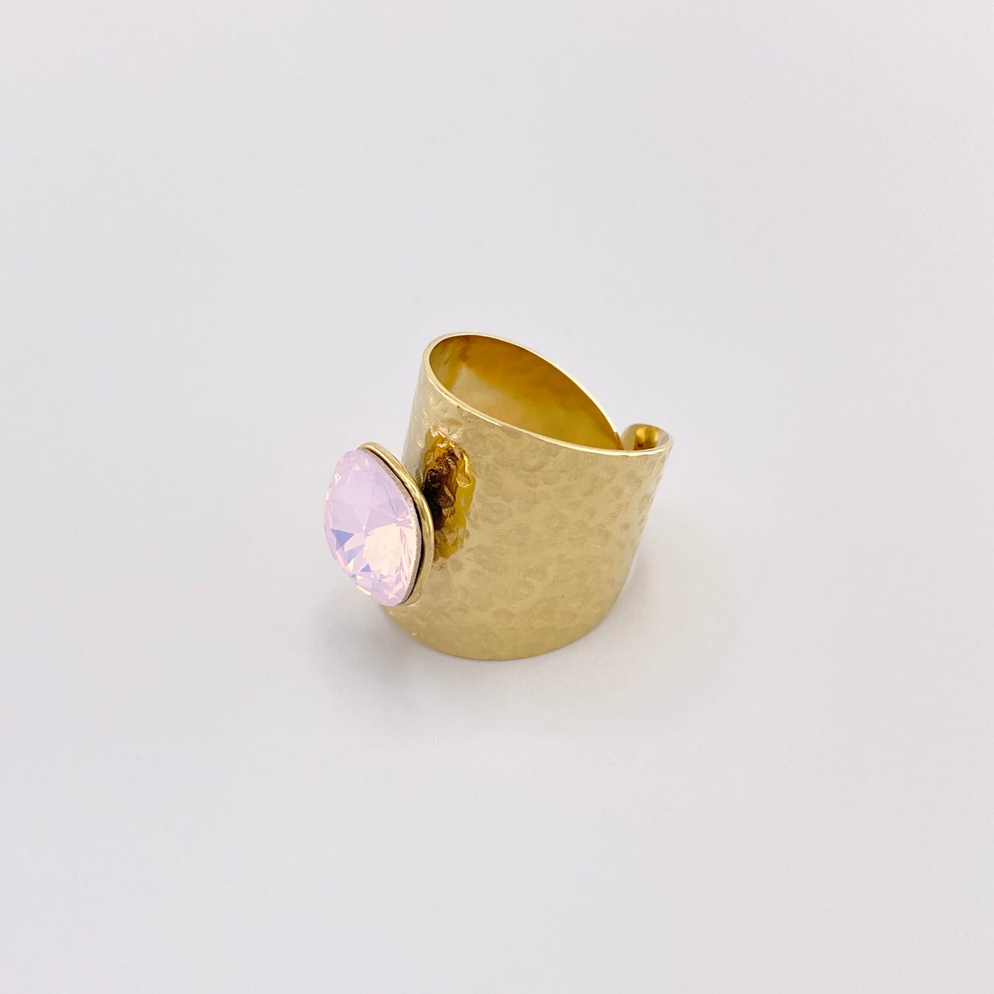 Gold-plated stainless steel ring with a hammered texture and a light pink crystal, French brand Bohm.