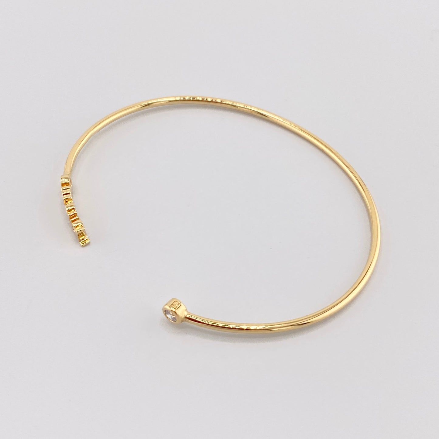 Vergoldetes Armreif mit der Gravur „Amour“ und einem Zirkonia-Detail, französische Marke IRL.