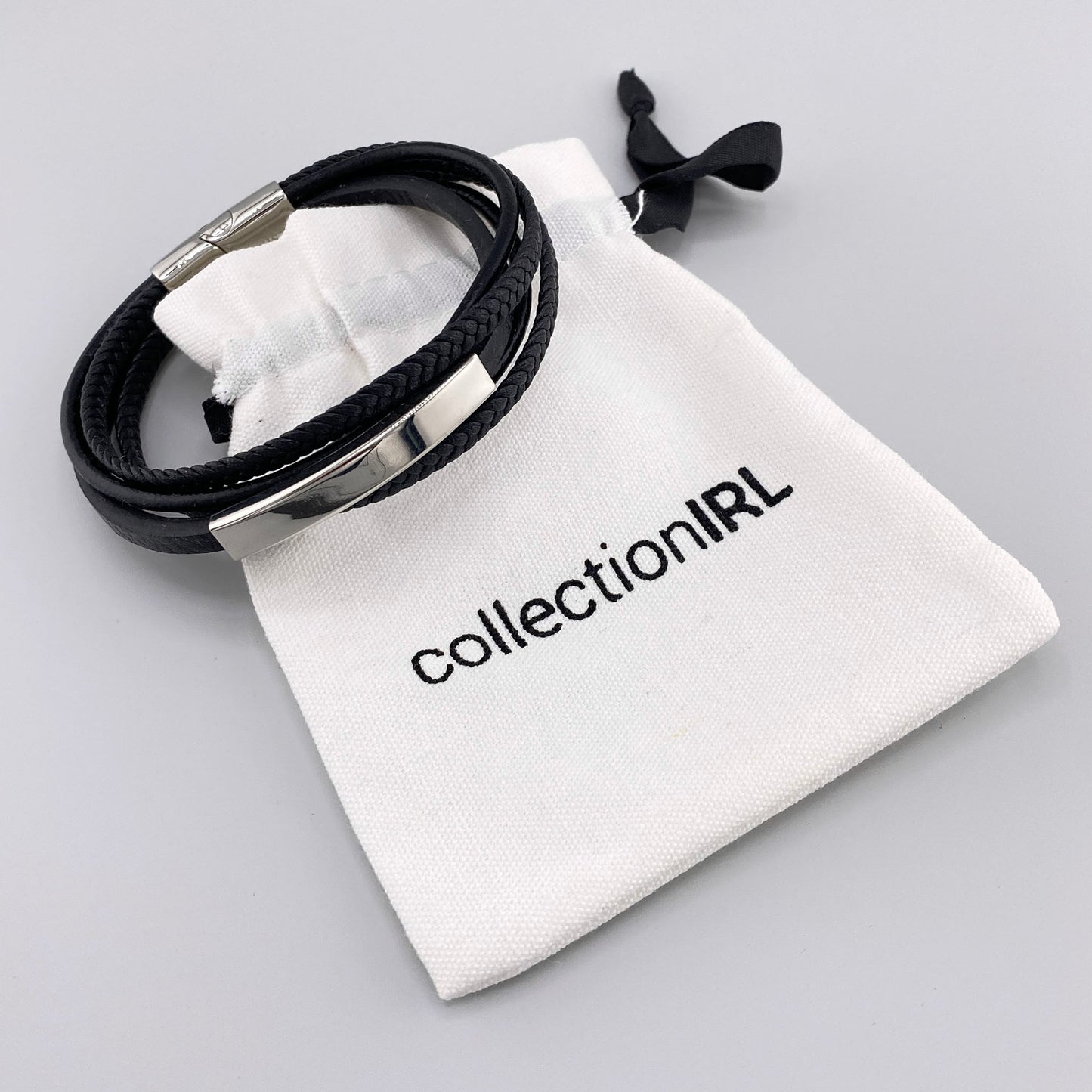 Men’s bracelet made of black genuine leather with braided and smooth straps, featuring a silver-tone stainless steel accent and magnetic clasp, French brand IRL.