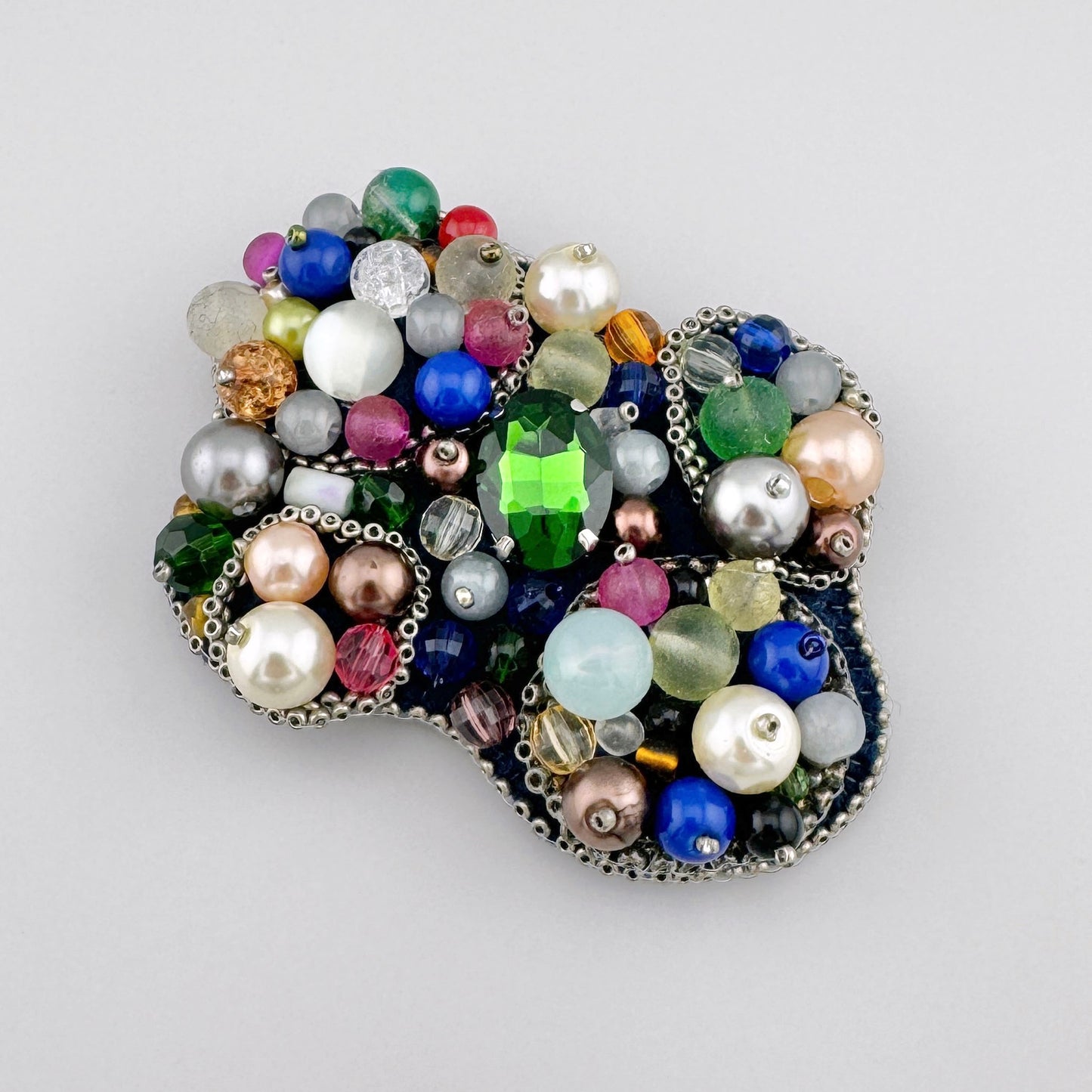Handcrafted brooch adorned with multicolored beads and a large green crystal, Polish brand BroszArt.