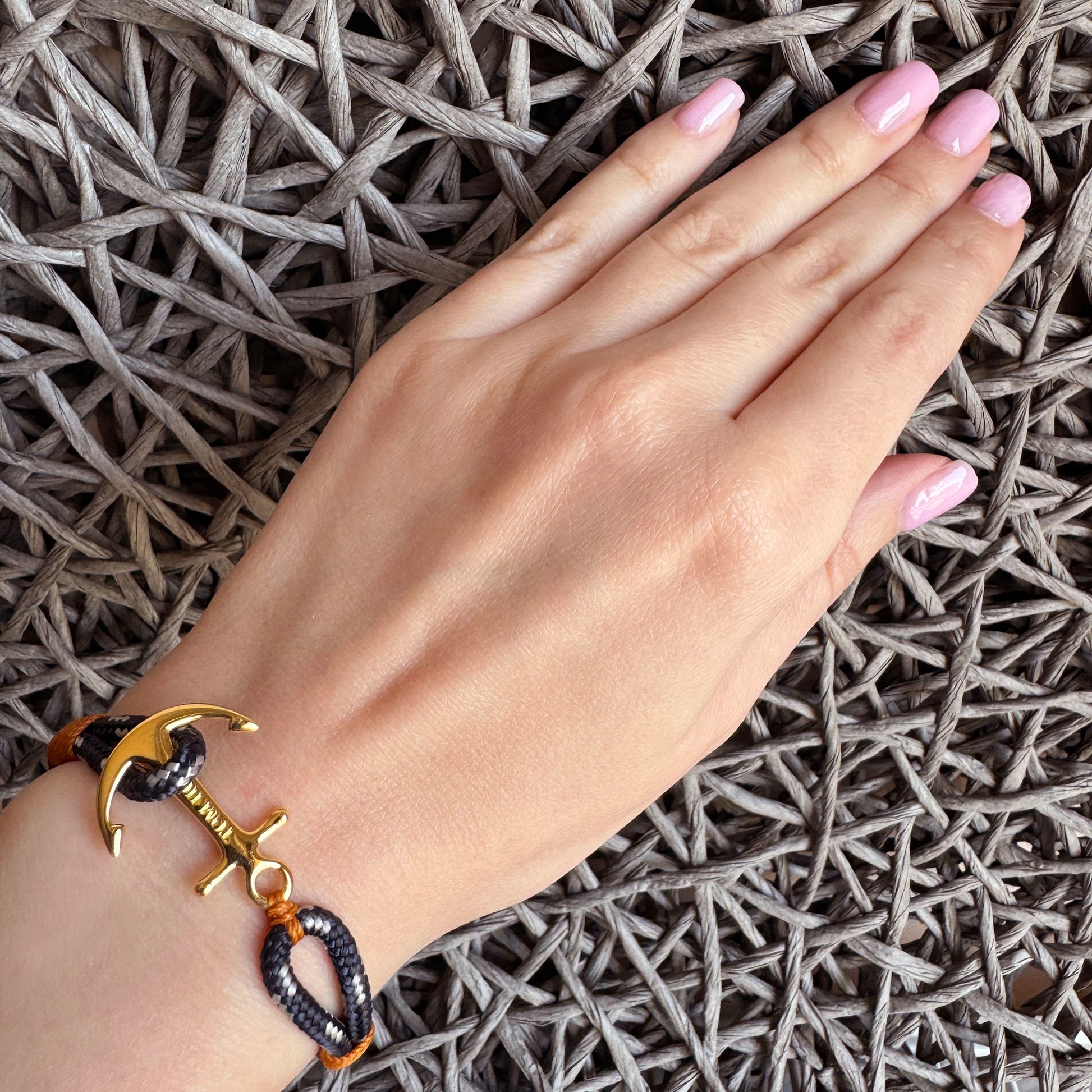 Tom Hope anchor bracelet with navy rope and gold-plated charm on wrist