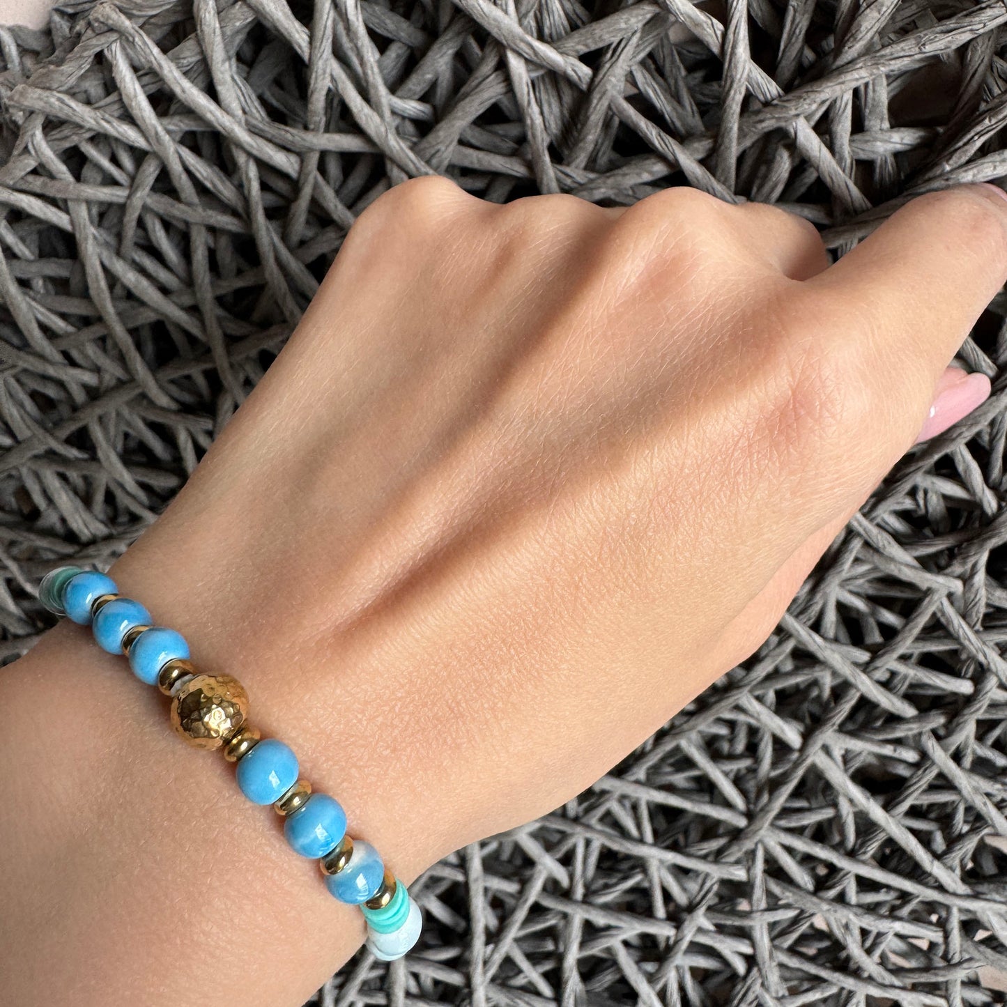 Blue and white ceramic bracelet with turquoise and gold details, summer-inspired design by Ikita.