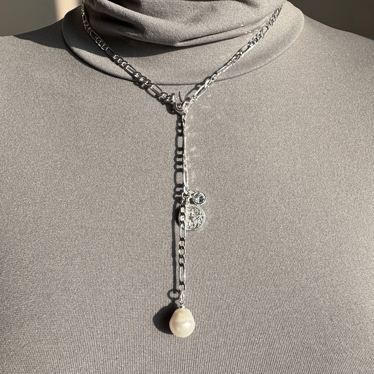 Elegant silver Pilgrim necklace with baroque pearl and medallion detail worn on neck