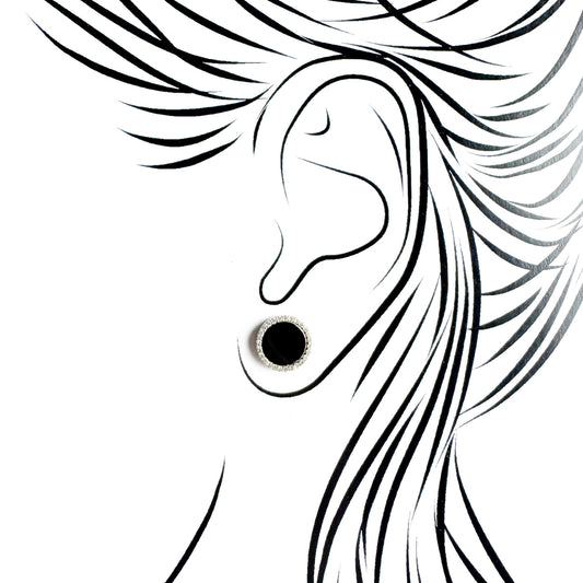 Silver black oval stud earrings Universe worn on the ear with a polished setting