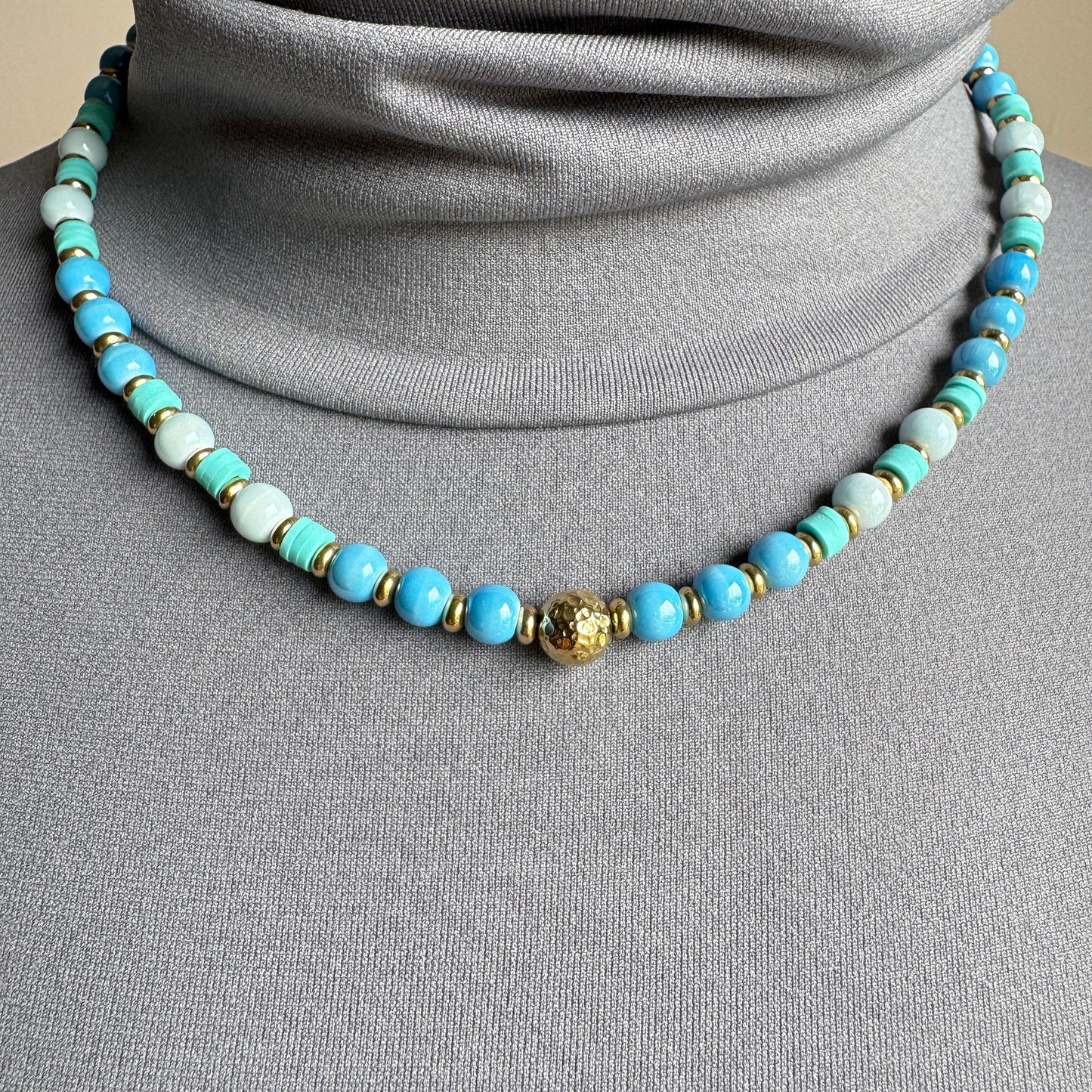 Pastel ceramic bead necklace with gold detail, elegant style by French brand Ikita.