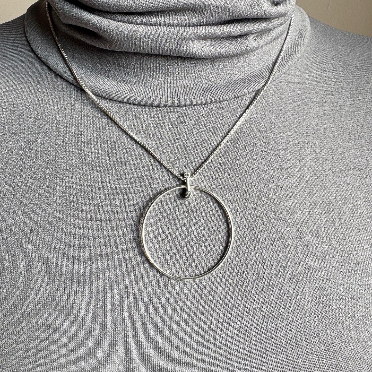 Elegant Pilgrim necklace with silver circle pendant and subtle cubic zirconia sparkle