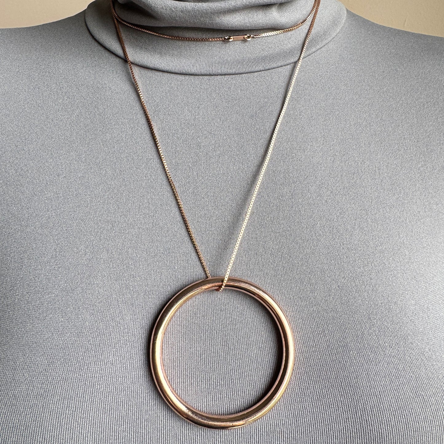 Elegant Pilgrim necklace with large circle pendant in rose gold tone on long chain
