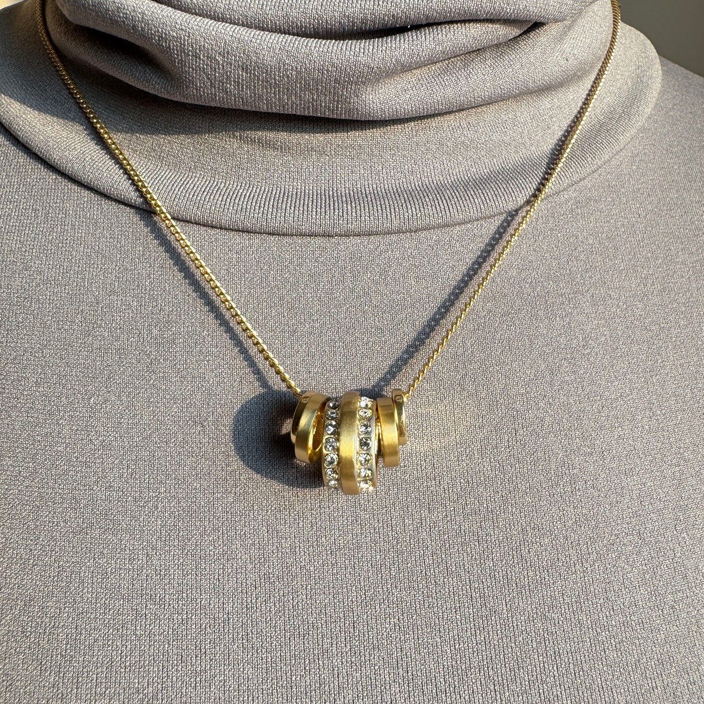 Pilgrim gold necklace with multiple round pendants and crystal accents