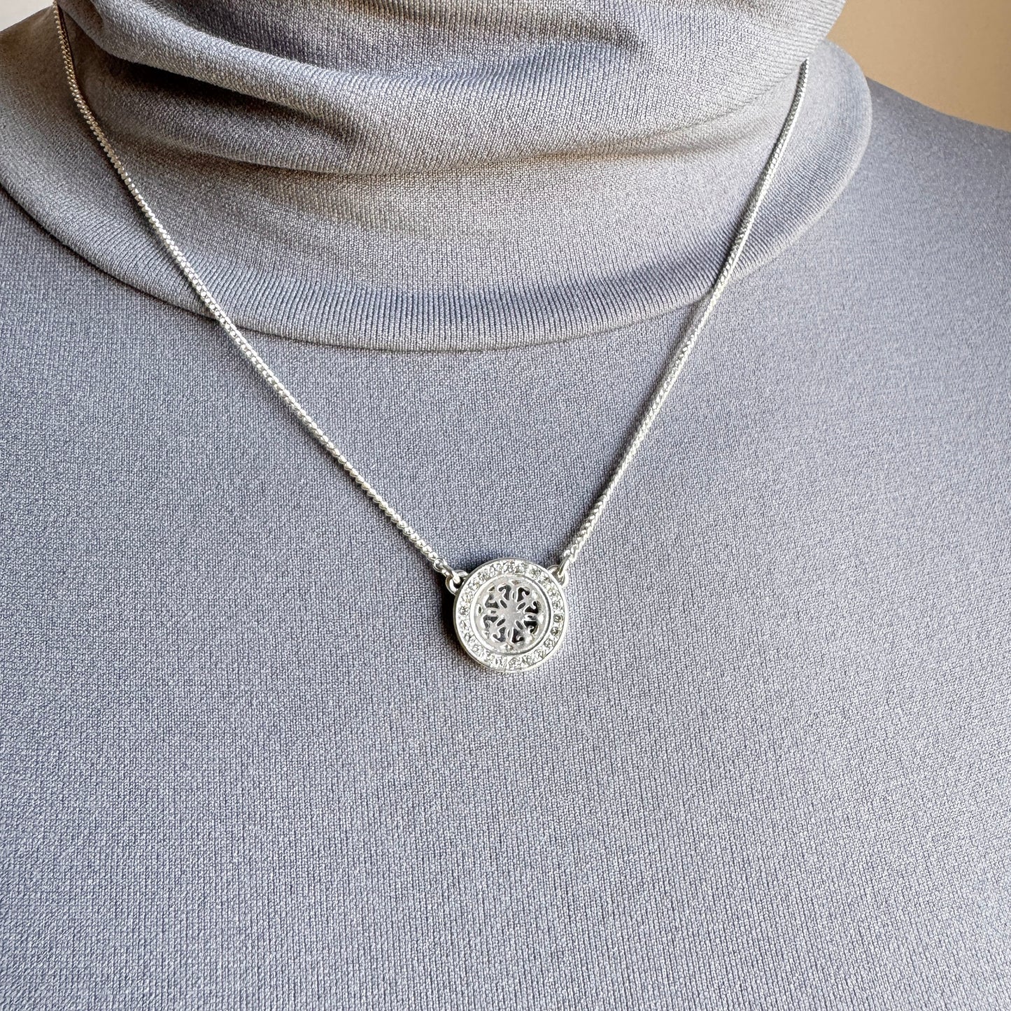 Delicate necklace with an openwork medallion and sparkling crystals for refined style