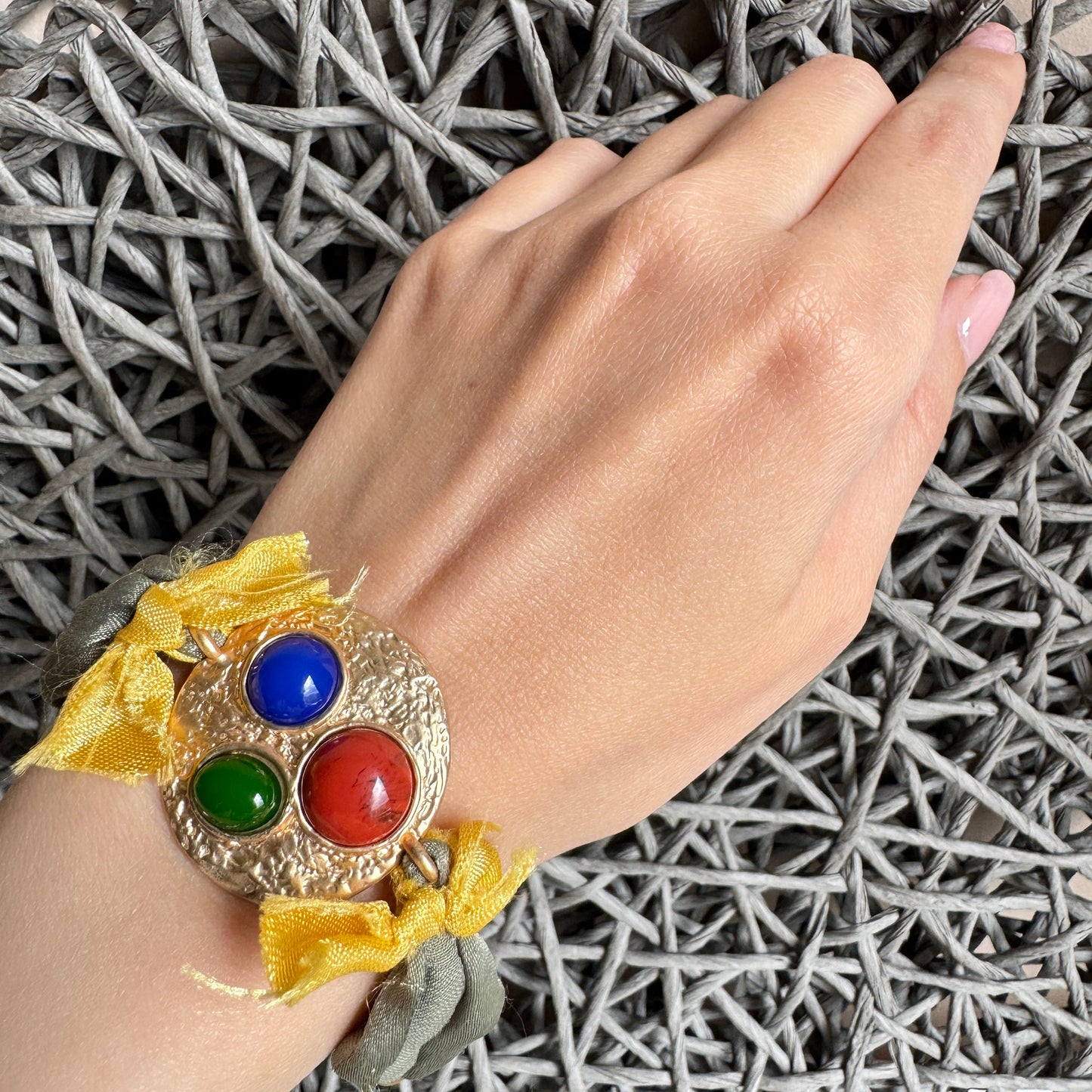 Sonata fabric bracelet with colorful cabochons and gold-tone hammered base worn on wrist