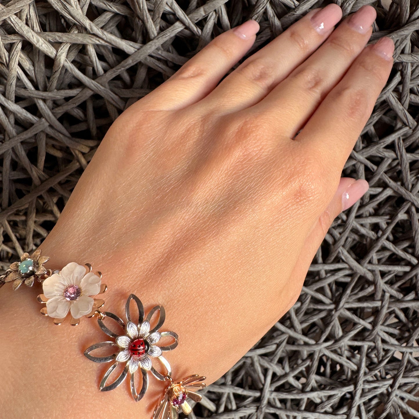 Handmade Reminiscence bracelet with floral charms and ladybug accent for elegant outfits