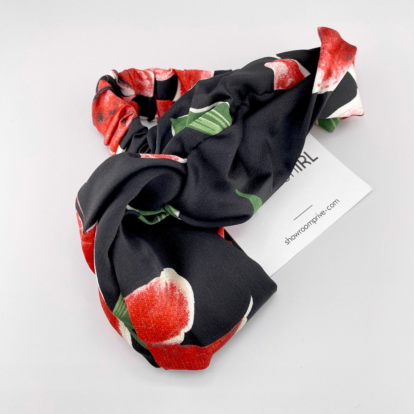 Black fabric headband with red floral pattern and satin sheen