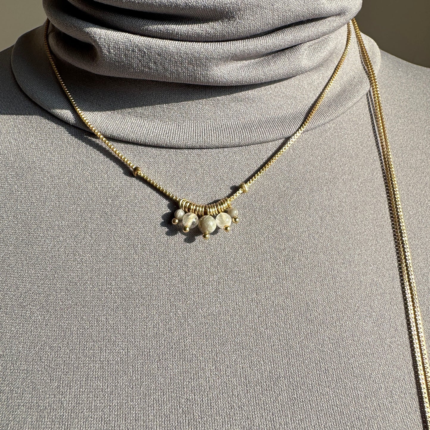 Elegant Pilgrim necklace with rose quartz and gold details worn as double choker