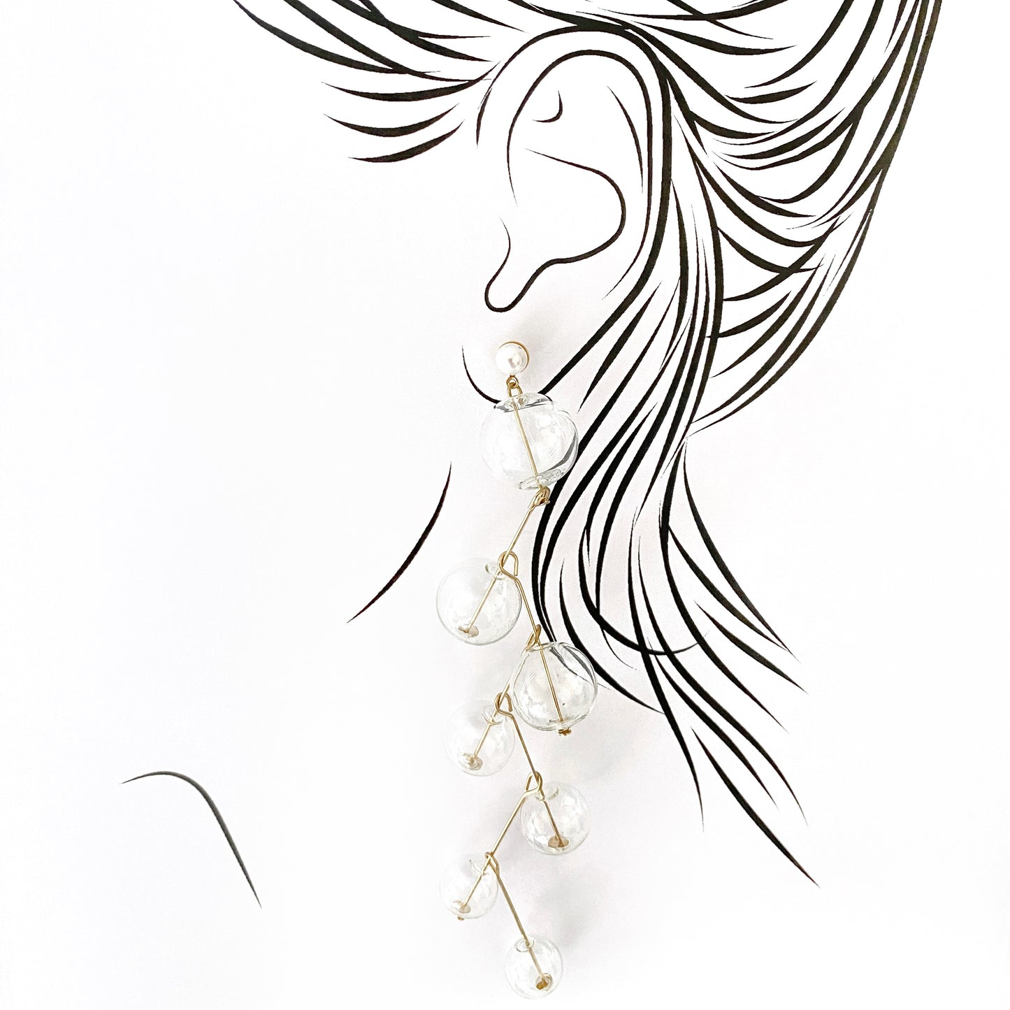 Elegant long earrings with clear glass beads and golden pins