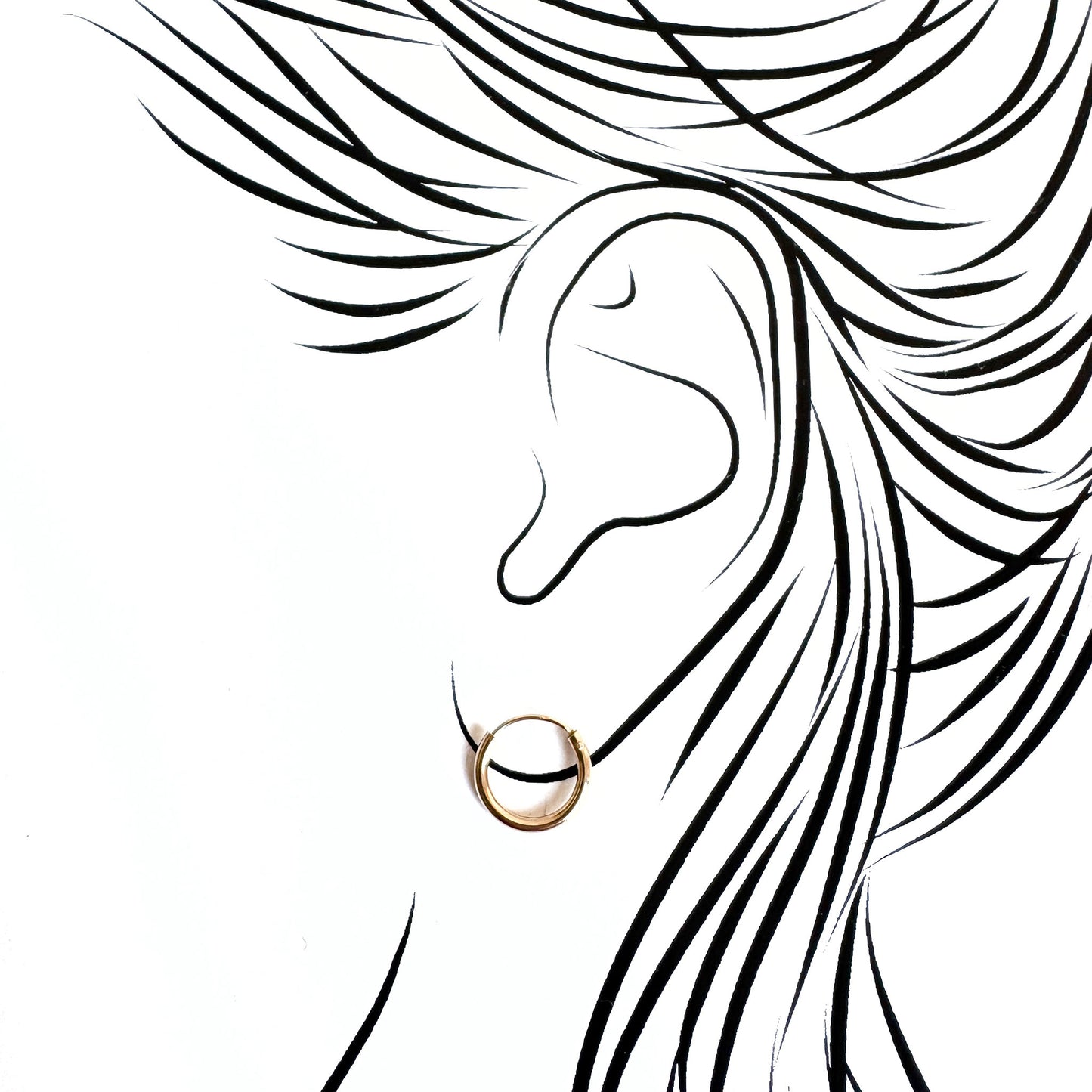 Minimal gold hoops hugging the earlobe with invisible closure