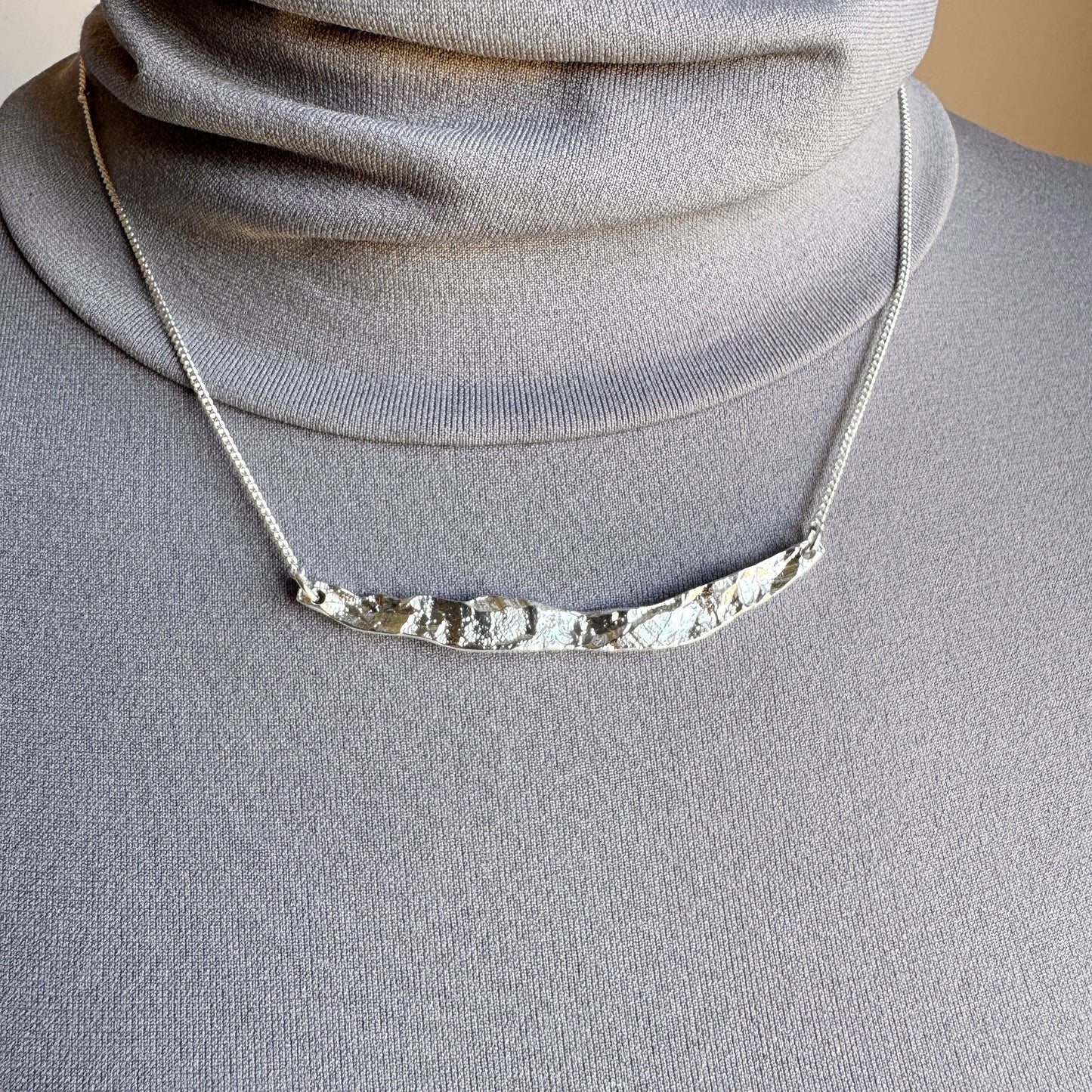 Elegant silver necklace with organic hammered texture and adjustable chain
