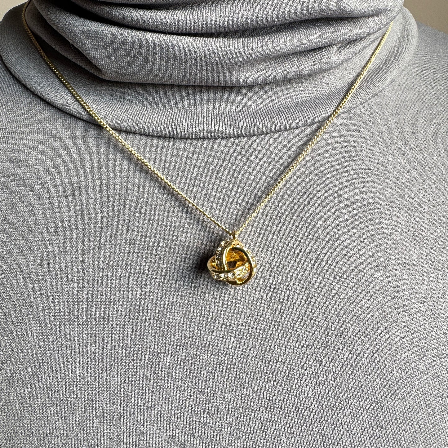 Elegant Pilgrim necklace with knot-shaped pendant and sparkling zirconia stones