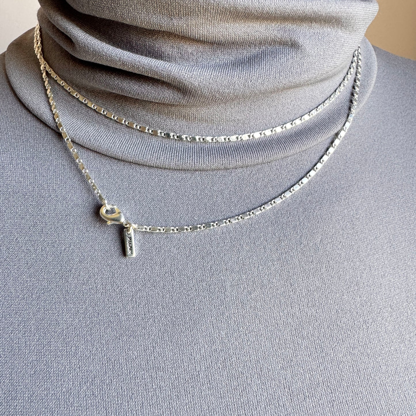Silver minimalist chain necklace with geometric details and adjustable clasp