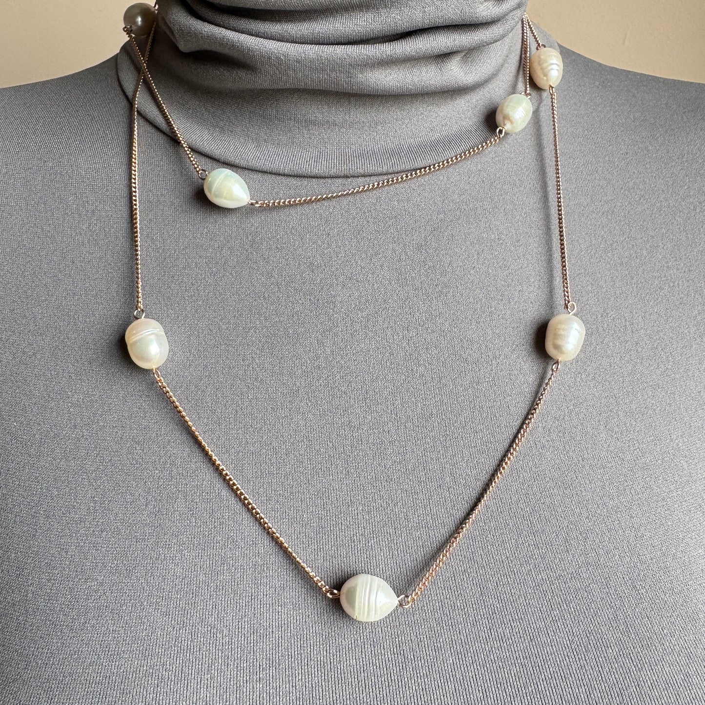 Long pearl necklace with irregular freshwater pearls worn single strand on a mannequin