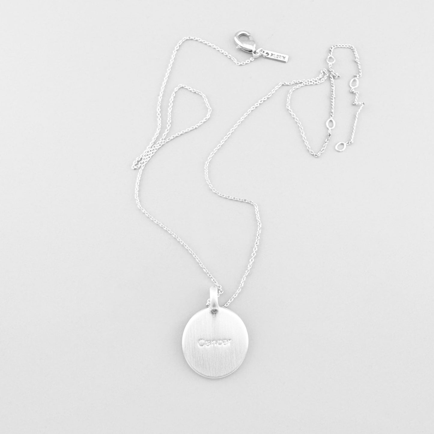 Pilgrim necklace with star-engraved round medallion displayed on light background