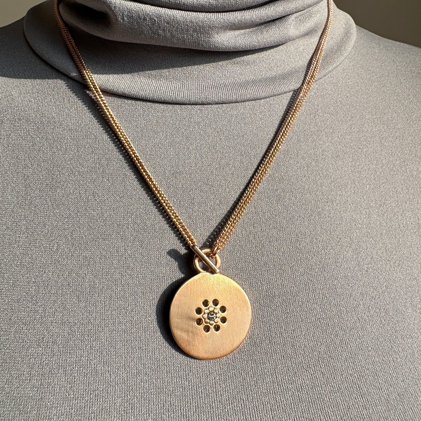 Elegant Pilgrim necklace with 2-in-1 medallion worn as short style close to neckline
