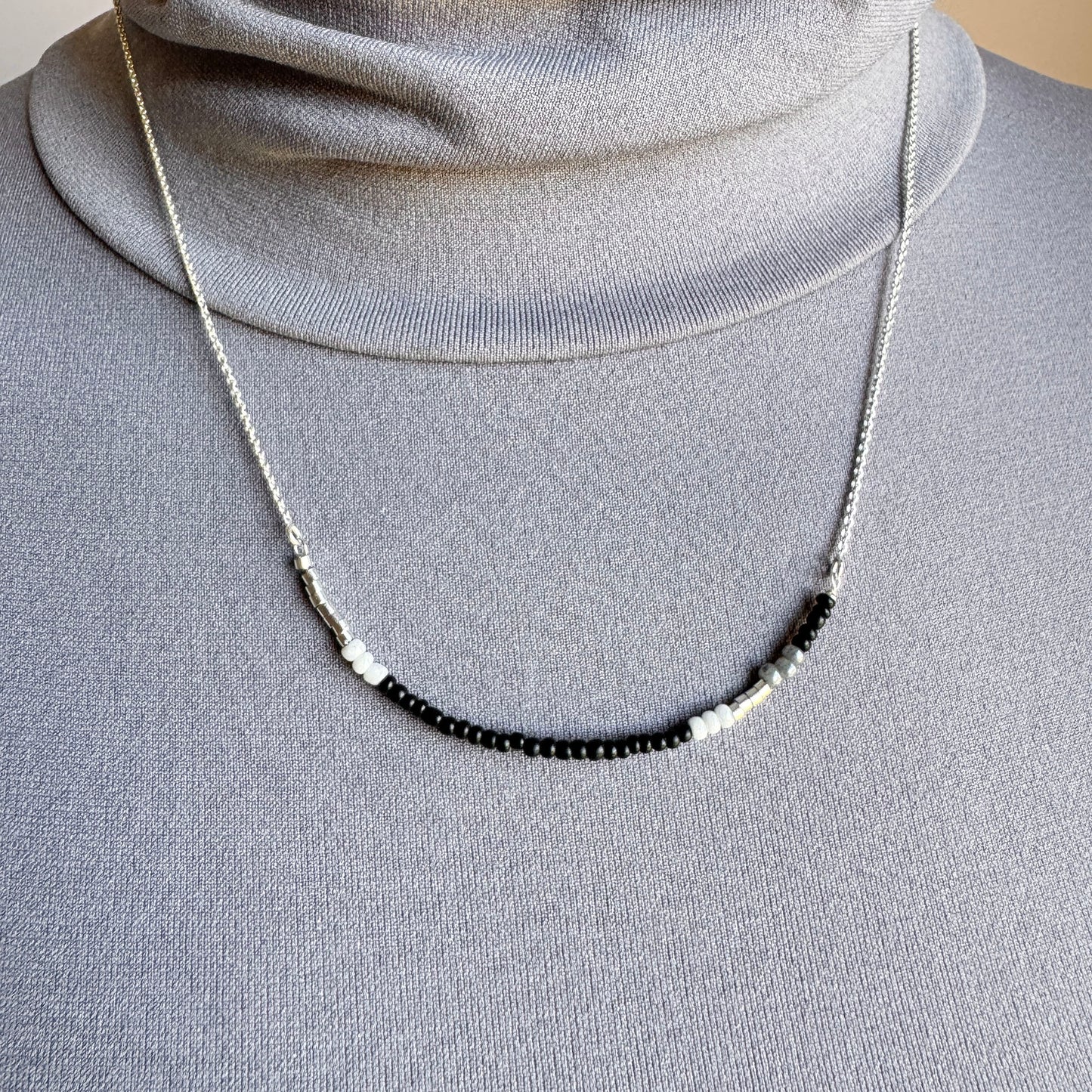 Sleek minimalist necklace with tiny contrast beads and polished chain